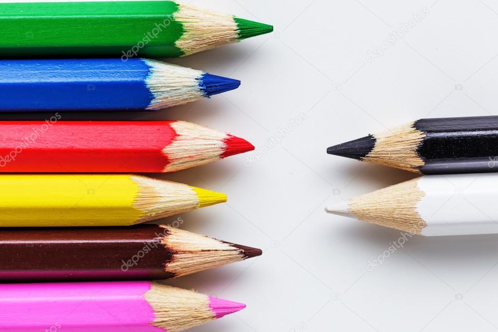 Black and white pencils in front of colorful pencils