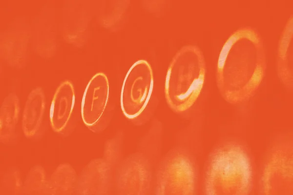 Orange glowing typewriter keys — Stock Photo, Image