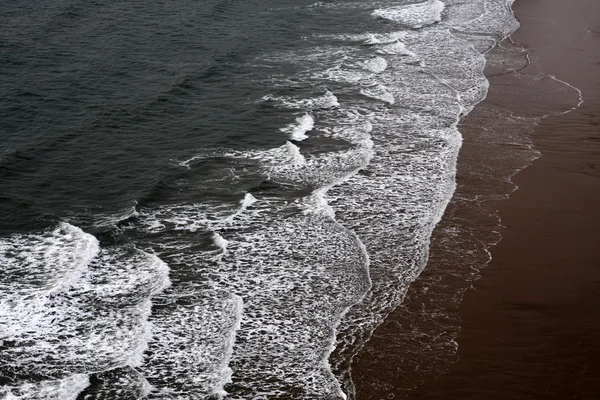 Golven die breken op een zandstrand — Stockfoto