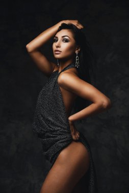 sexy raven indian lady posing seductively in front of camera