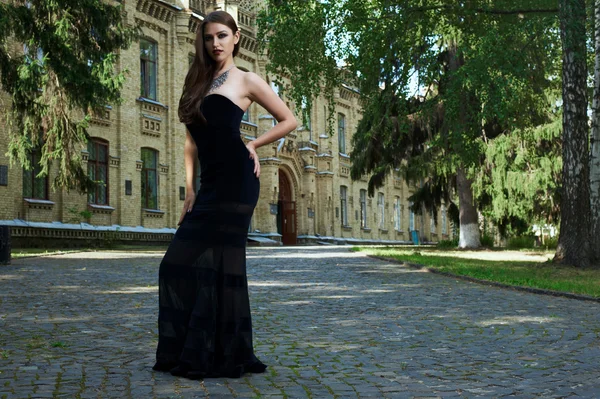 Sexy woman in black dress and necklace — Stock Photo, Image