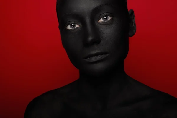 Close-up portrait of woman in black paint — Stock Photo, Image