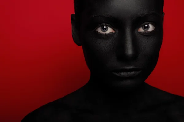 Close-up portrait of woman in black paint — Stock Photo, Image