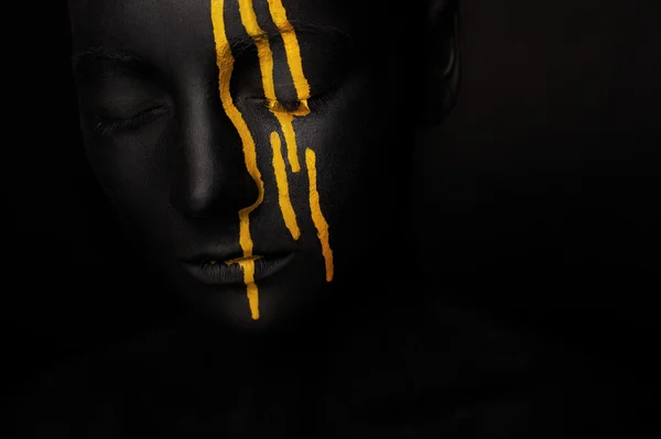 Lady in black paint with yellow smudges — Stock Photo, Image