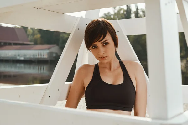 Close-up of brunette with short haircut under volleyball seat — Stock Photo, Image