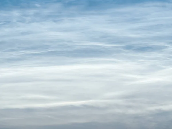 Starry sky with noctilucent clouds at summer solstice night. Fantastic cloudscape. Natural pattern, texture, background, wallpaper, graphic resources, design, abstract art, copy space.