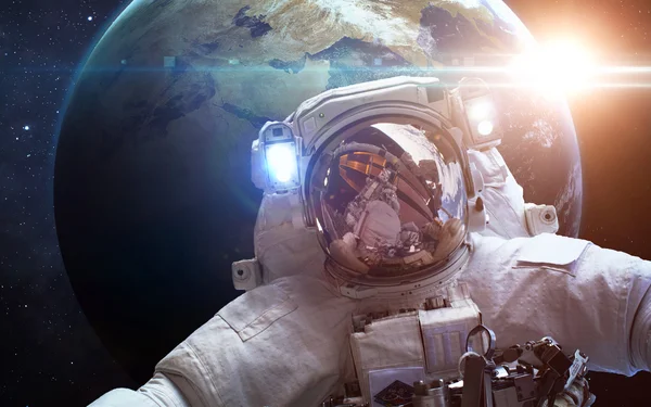 Astronaut in space over the planet Earth. Elements of this image furnished by NASA — Stock Photo, Image