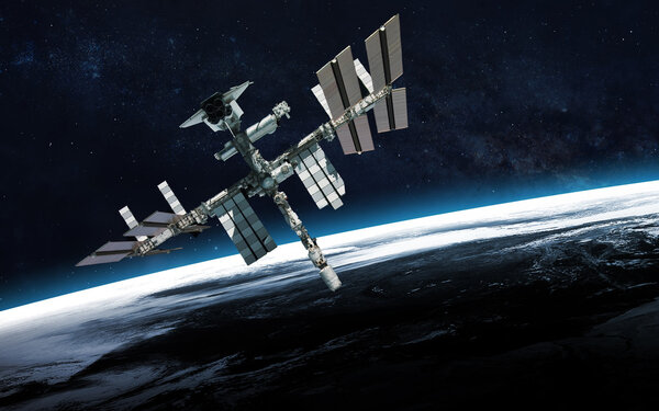 International Space Station over the planet Earth. Elements of this image furnished by NASA