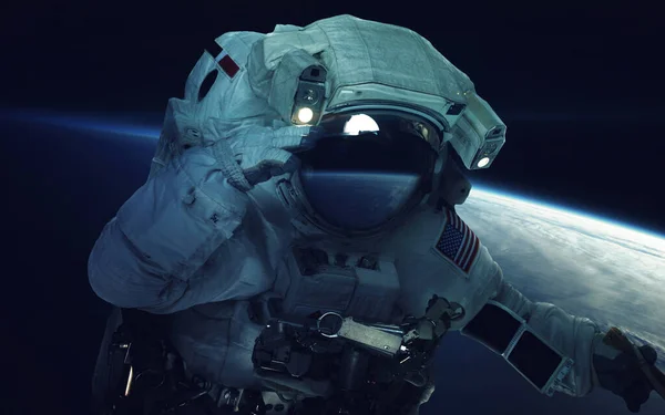 Astronaut at spacewalk. Cosmic art, science fiction wallpaper. Beauty of deep space. Billions of galaxies in the universe. Elements of this image furnished by NASA — Stock Photo, Image