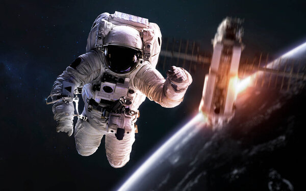 Astronaut at spacewalk, satellite orbiting Earth planet. Elements of this image furnished by NASA