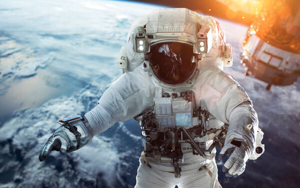 Brave astronaut at the spacewalk at the Earth orbit. People in space. Elements of this image furnished by NASA