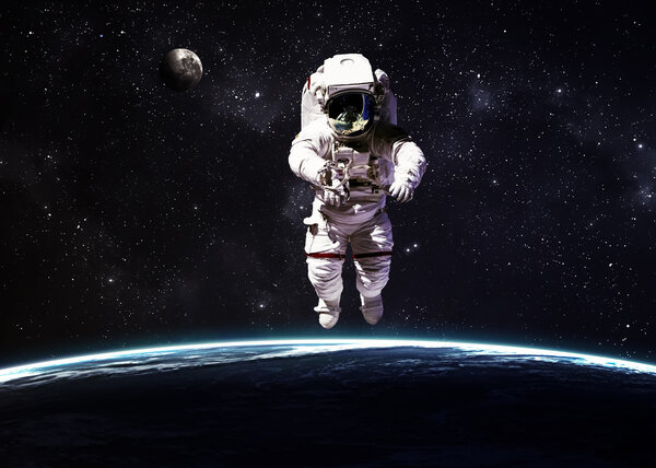 Astronaut in outer space against the backdrop of the planet earth