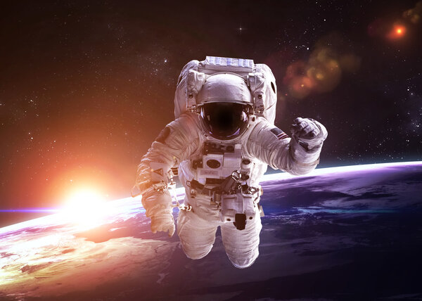 Astronaut in outer space against the backdrop of the planet