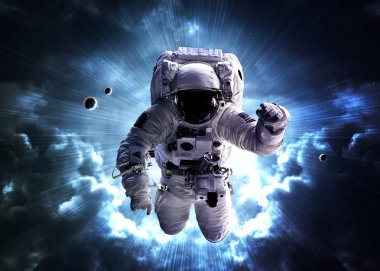 An astronaut floats above billions of stars. Stars provide the background. Elements of this Image Furnished by NASA.