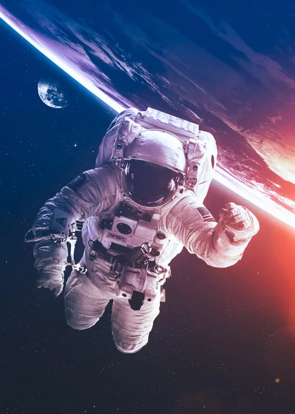An astronaut floats above billions of stars. Stars provide the background. Elements of this Image Furnished by NASA. — Stock Photo, Image