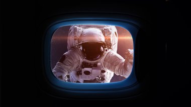 Beautiful cosmos in space ship window porthole. Elements of this image furnished by NASA.