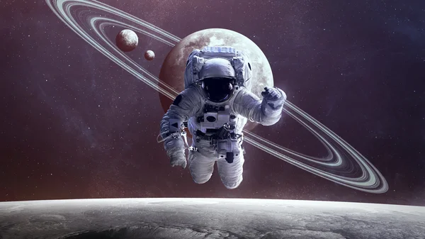 Astronauta no espaço sideral contra o pano de fundo do planeta. Elementos desta imagem fornecidos pela NASA . — Fotografia de Stock