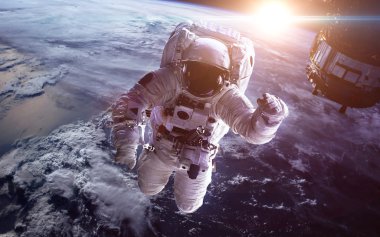 Uzaydaki astronot, Dünya gezegeninin arka planına karşı. Bu görüntünün elementleri NASA tarafından desteklenmektedir