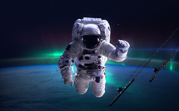 International Space Station with astronaut over the planet Earth. Elements of this image furnished by NASA