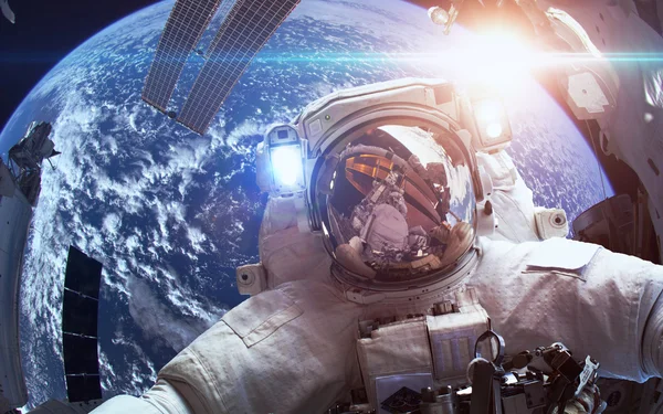 International Space Station with astronaut over the planet Earth. Elements of this image furnished by NASA — Stock Photo, Image