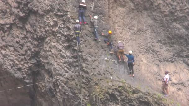 Group Of Unidentified People Crossing Over Tibetan Bridge In Banos De Agua Santa — Stock Video