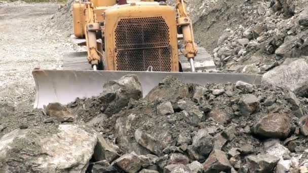 Front View Of Bulldozer Moving Rocks Toward Camera — Stock Video