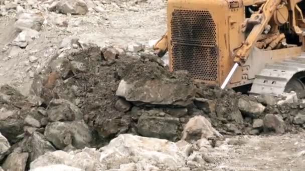 Bulldozer Movendo grande quantidade de rochas soltas, abrandando Panning direita para a esquerda — Vídeo de Stock