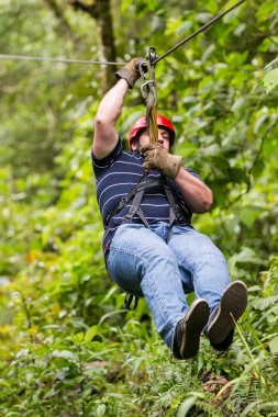 Oversized Adult Man On Zip Line clipart