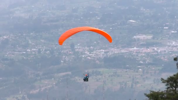 Solo Paraglide Flying Against Populated Area In Andes — Stock Video