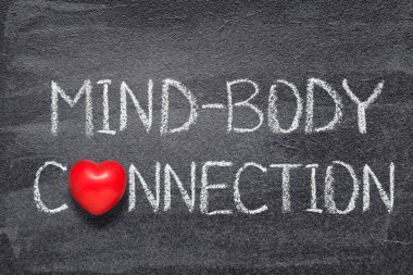 Kara tahtaya kırmızı kalp sembolü ile yazılmış zihin-beden bağlantısı ifadesi