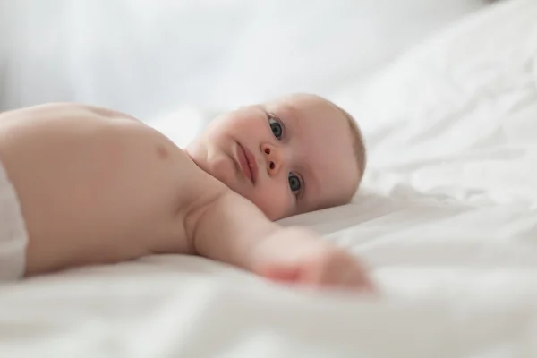 男婴在白色阳光明媚的卧室里 — 图库照片