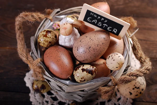 Easter eggs and decoration in old basket — Stock Photo, Image