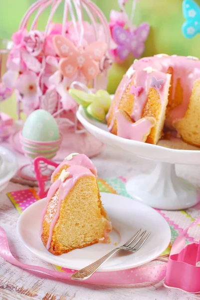 Osterringkuchen mit rosa Zuckerguss und schmetterlingsförmigem Zuckerspri — Stockfoto