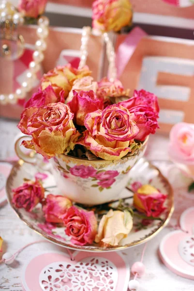 Beautiful dried roses in porcelain teacup Royalty Free Stock Photos