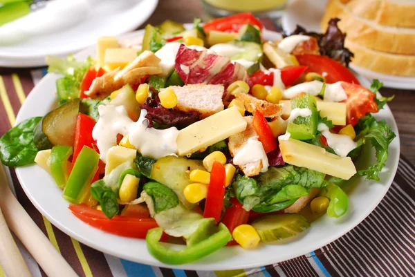 Chicken salad with cheese and vegetables — Stock Photo, Image