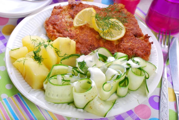 Delicious dinner with pork chop and cucumber salad — Stock Photo, Image