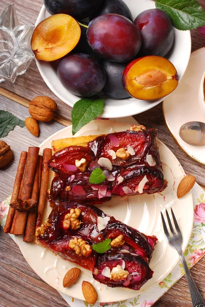 Piece of plum cake with nuts and spices — Stock Photo, Image