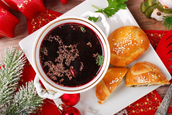 Red borscht and pastries for christmas eve — Stock Photo, Image