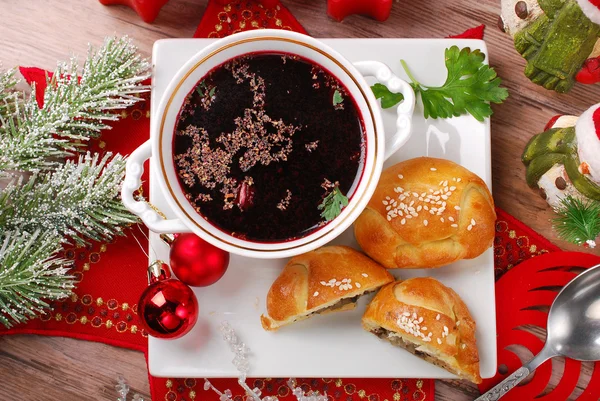 Red borscht and pastries for christmas eve — Stock Photo, Image