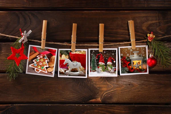 Christmas photos hanging on rope against wooden background — Stock Photo, Image