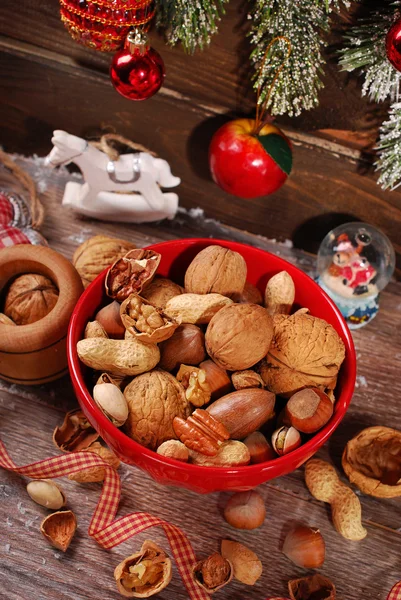 Nuts assortment in bowl on wooden table for christmas — Stock Photo, Image