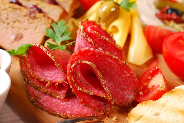 Wooden board with appetizer — Stock Photo, Image