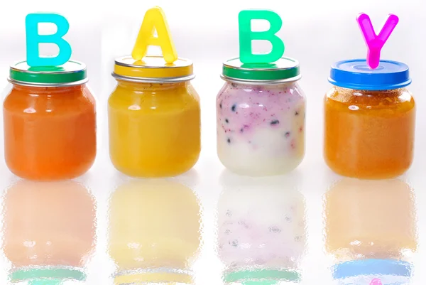 Baby food in jars on the glass — Stock Photo, Image