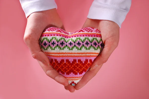 Woolen heart in hands — Stock Photo, Image