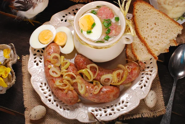 Easter white borscht and sausage on rural wooden table — Stock Image Easter white borscht and sausage on rural wooden table Royalty Free Stock Photos