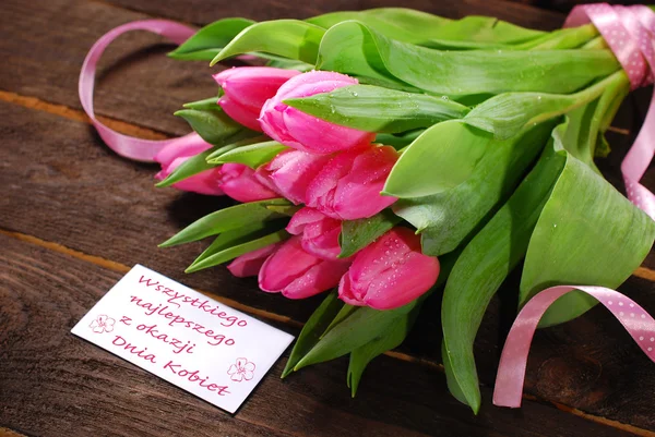 Bunch of fresh pink tulips and card with greetings — Stock Photo, Image