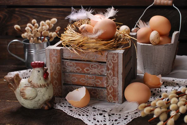 Rustic still life with eggs in nest on wooden box for easter — Stock Photo, Image