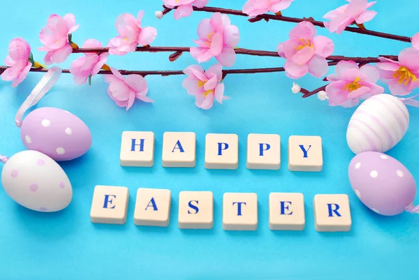 Easter background with greetings and blooming tree branch — Stock Photo, Image