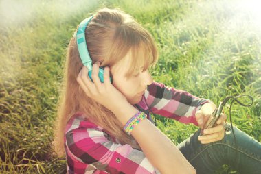 girl listening music on the meadow in vintage style  clipart