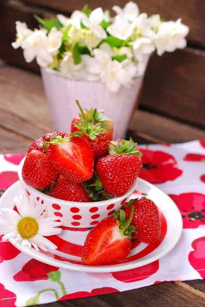 Kom van verse aardbeien op houten tafel — Stockfoto